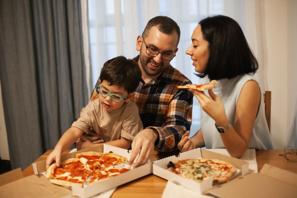 happy family eating pizza at home, pizza delivery and candid everyday lifestyle moments